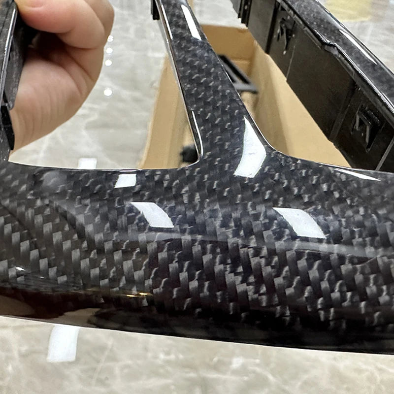 Détail du contour d’autoradio BMW en finition carbone brillant